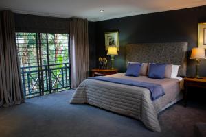比勒陀利亚Koru Guesthouse的一间卧室设有一张床和一个大窗户