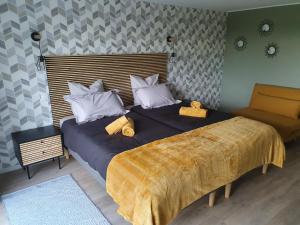 泰朗库尔Gite Le Gouttis的一间卧室配有一张带黄色毯子的大床