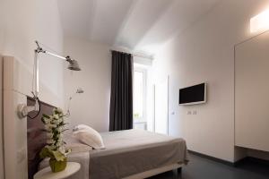 罗马乌贝斗兽场酒店的白色的卧室设有床和窗户