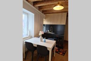 圣克鲁瓦Petit bijou de Sainte-Croix的厨房配有白色的桌椅和水槽