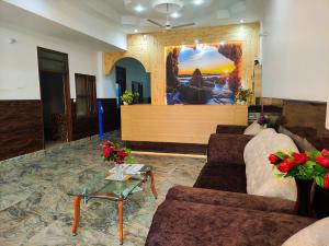 钱德加尔Rebirth Hotel的大厅配有沙发和桌子,位于客房内