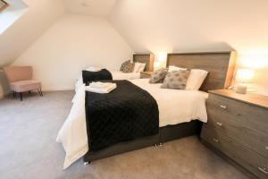 布罗德福德Black Barn Skye - Contemporary 3 bed / 4 bath home的阁楼上的卧室配有两张床