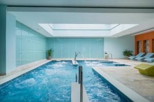 蒙特哥贝玫瑰堂海滩伊波罗之星酒店&度假村的蓝色墙壁的房间内的游泳池