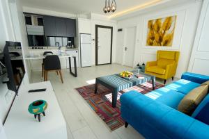 内夫谢希尔Viva Suites Cappadocia的一间带蓝色沙发的客厅和一间厨房