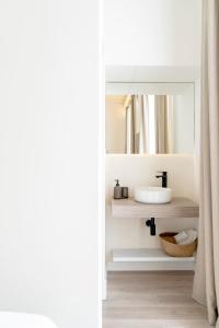 赫雷斯-德拉弗龙特拉Suites Alfonso X的一间带水槽和镜子的浴室