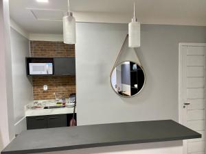马卡帕Apartamento Studio Centro de Macapá的厨房配有水槽和墙上的镜子