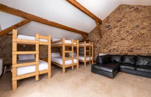 雷文格拉斯Muncaster Castle Coachman's Quarters的一间带双层床和沙发的客厅
