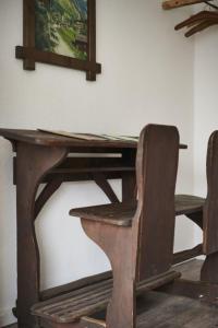 巴特贝勒堡Fewo Bubenberg的一张木桌、椅子和墙上的照片
