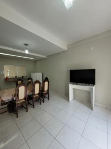 科伦巴Sobrado 4 amplo e confortável em condomínio的客厅配有桌椅和电视。