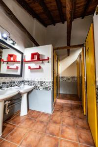 格拉纳达Amaka House的浴室设有两个水槽和红色架子