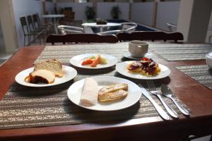 特里温福Hotel Encanto do Sertão的一张木桌,上面放着食物盘