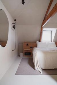 鹿特丹Hotel âme的卧室配有白色的床和窗户。