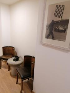 奥里奥阿塞里奥Ferrari Formula 1的一间房间,配有两把椅子和一张墙上的照片