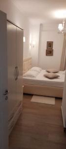 科帕罗Vogklis House的一间白色卧室,配有一张床和一个梳妆台
