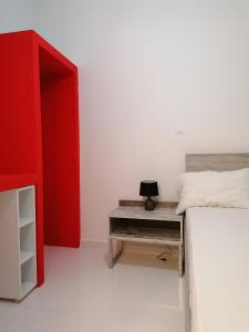 罗德镇Jz Plus Classio的一间卧室配有红色的床和一张书桌