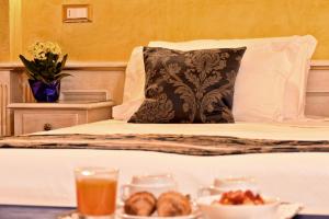 威尼斯阿琵亚韦酒店的一张带枕头的床和一盘食物