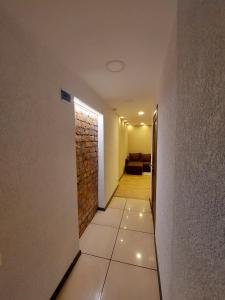古尔贝内M14 Apartment的走廊设有瓷砖地板和砖墙