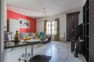 隆达Apartamentos Alameda del Tajo I Parquing Centro的一间厨房,里面设有红色的墙壁和一张桌子