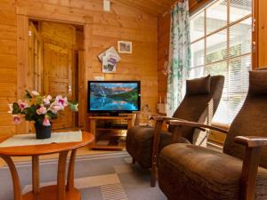 拉赫登佩拉雅佩荷雷波度假屋的客厅配有电视、沙发和桌子