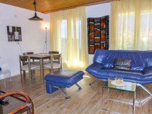 格林德尔瓦尔德Apartment Chalet Albi by Interhome的客厅配有蓝色的沙发和桌子