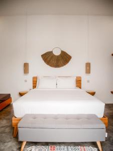 外南梦Betah Homestay Banyuwangi的卧室配有白色的床和沙发