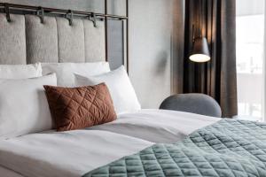 奥斯陆Quality Hotel Hasle Linie的一间卧室配有一张床和一把椅子