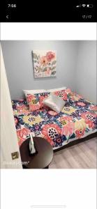 巴尔的摩Nice bedroom next fells point的一间卧室配有一张带花卉床罩和桌子的床。