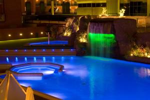 马尔格莱特德玛帕皮酒店的夜间游泳池,设有瀑布