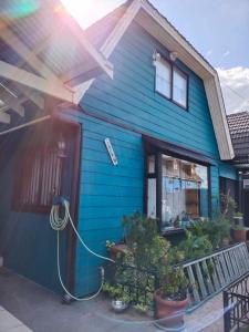 蒙特港lotus shared-house的前面有软管的蓝色房子