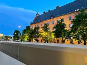 马尔默HOTEL N Hostel Malmö City的一座大型红砖建筑,前面有树木