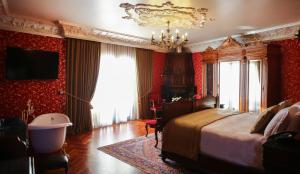 都拉斯Hotel Epidamn Boutique & Spa的一间卧室配有一张大床和一个吊灯。