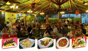 利比里亚蓝河温泉度假酒店的一群人坐在餐厅里,吃上盘子