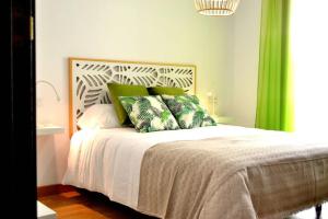 莫纳奇尔Monachil Apartamento La Vereda recién estrenado的一间卧室配有一张带绿色窗帘的床