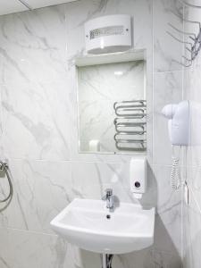 维尔纽斯"AVA" apgyvendinimo įstaiga的白色的浴室设有水槽和镜子