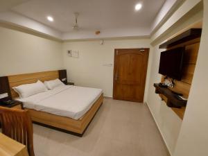 Hotel Sree Gokulam Apartments客房内的一张或多张床位