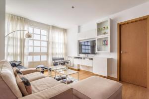 拉科鲁尼亚Precioso apartamento nuevo en el centro de A Coruña!的客厅配有沙发和桌子