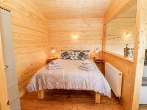 达灵顿Badgers Sett的小木屋内一间卧室,配有一张床