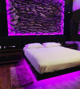 格拉玛多Amore Mio (Adult Only)的一间卧室配有一张紫色灯床