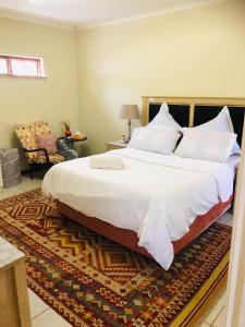 鲁德普特Lovely self catering first floor apartment的卧室配有一张带白色床单和枕头的大床。