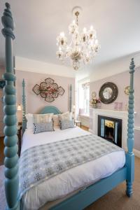 诺里奇阿森贝利酒店的一间卧室配有蓝色的床和吊灯。