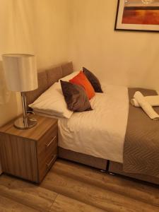 利物浦The Symphony Apartment的一间卧室配有两张床和床头灯。