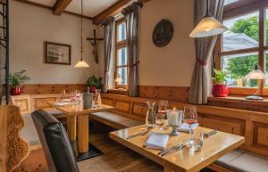 基姆湖畔普林Hotel Luitpold am See的餐厅设有木桌、椅子和窗户。