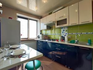 博布鲁伊斯克Apartament on Sovetskaya 135的厨房配有蓝色橱柜和白色台面