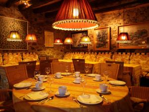 萨连特加列戈Hotel Almud的用餐室配有桌椅和灯光