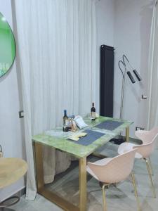 那不勒斯Gians B&B的一张带两把椅子和一盏灯的绿桌