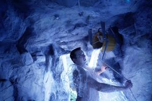 坎德施泰格多尔登峰森林酒店的一个人在瀑布的洞穴里