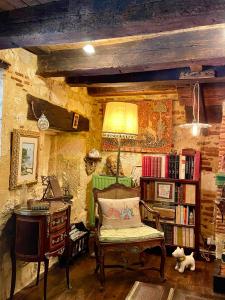 贝尔热拉克乐科隆比耶德西拉诺等罗克珊酒店的客厅配有椅子和书架