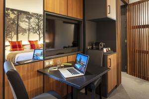 Chandolas墙壁旅馆的客房设有一张带笔记本电脑和一张床的书桌
