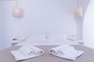 阿吉奥斯普罗科皮奥斯Naxos Sandastic的白色卧室,床上配有白色毛巾