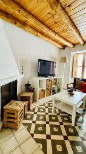 利纳雷斯德拉谢拉La Cantarera的客厅配有桌子和电视